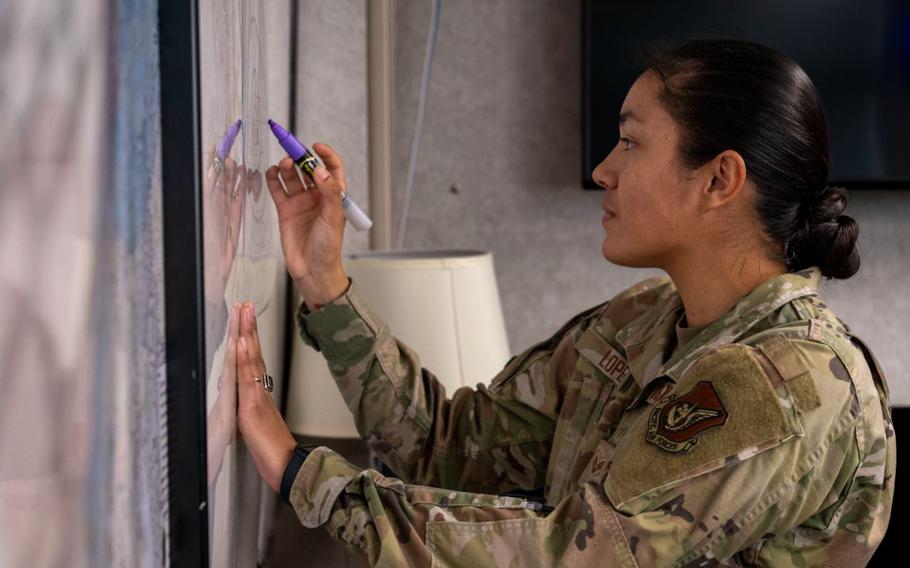 U.S. Air Force Senior Airman Nayeli Lopez, 18th Operational Support Squadron airfield management journeyman, reviews airspace at Kadena Air Base.
